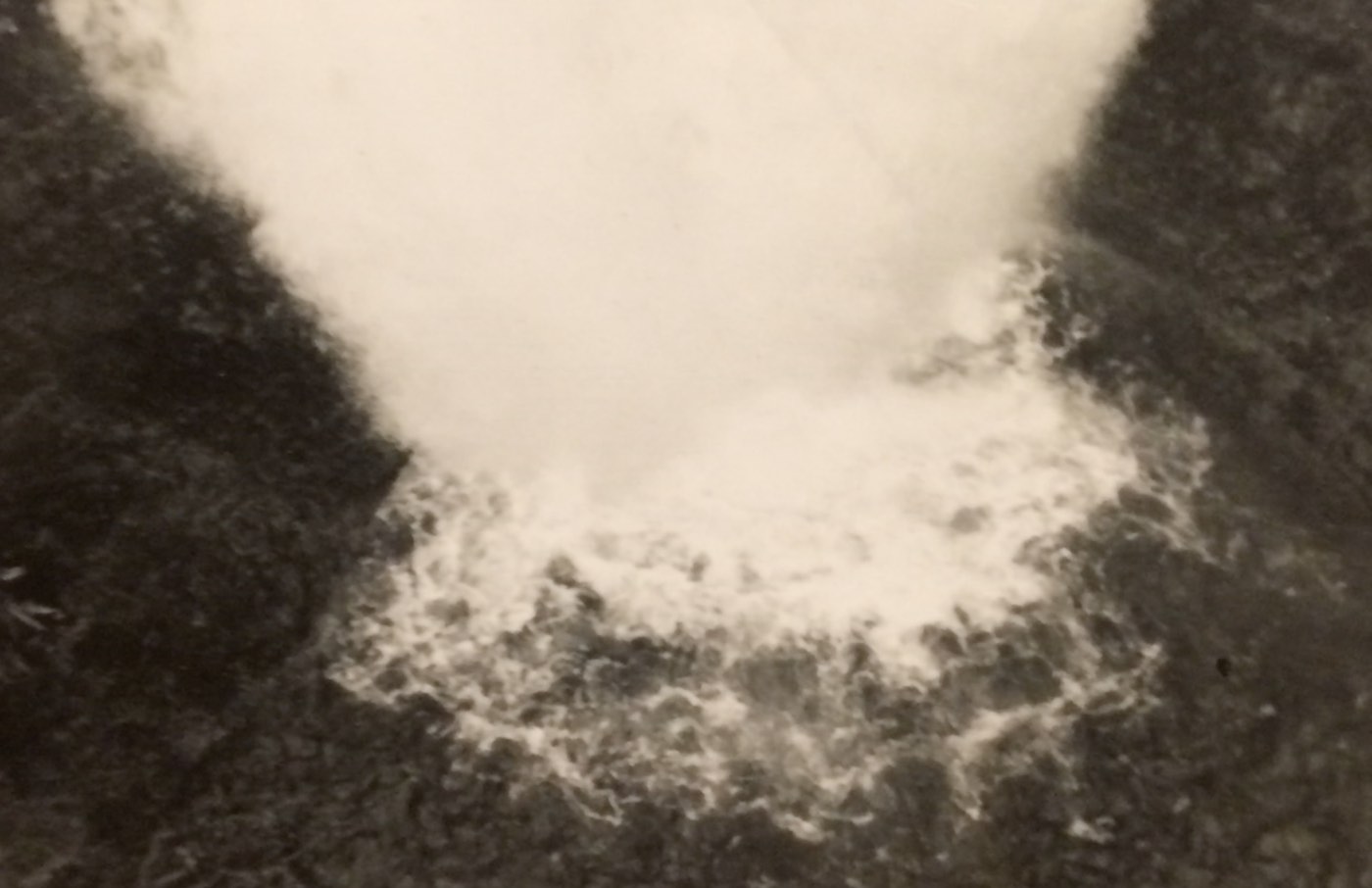 A sepia-toned photograph of a waterfall.